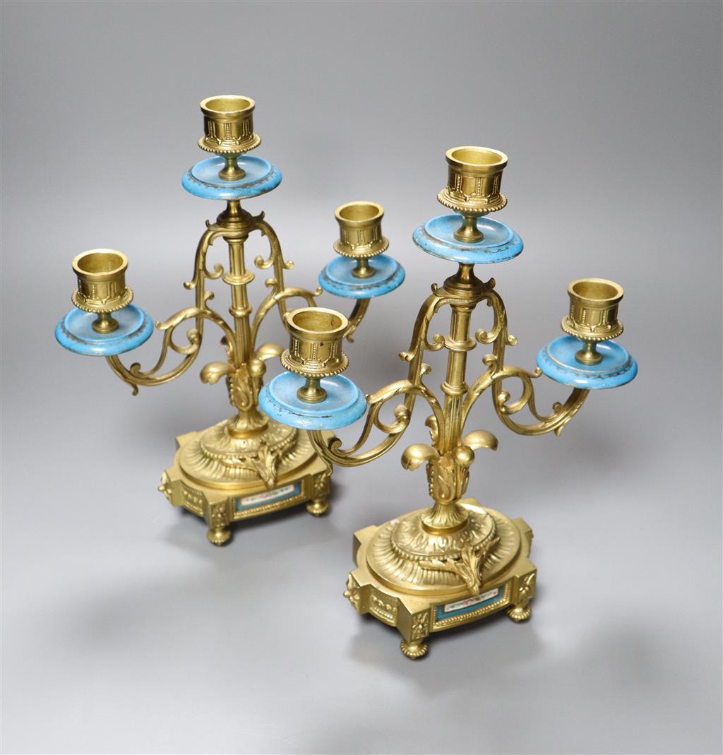 An early 20th century pair of ormolu and porcelain candelabra, with Sevres style plaques to base, height 28cm